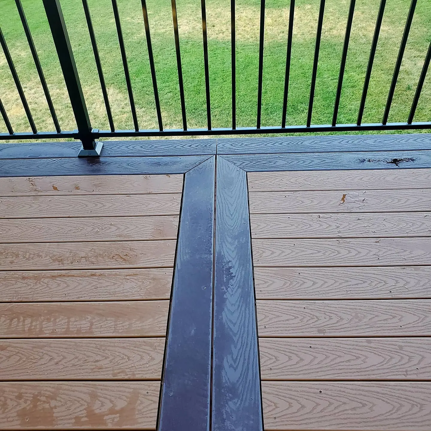 Dark breaker board dividing a two-tone composite deck