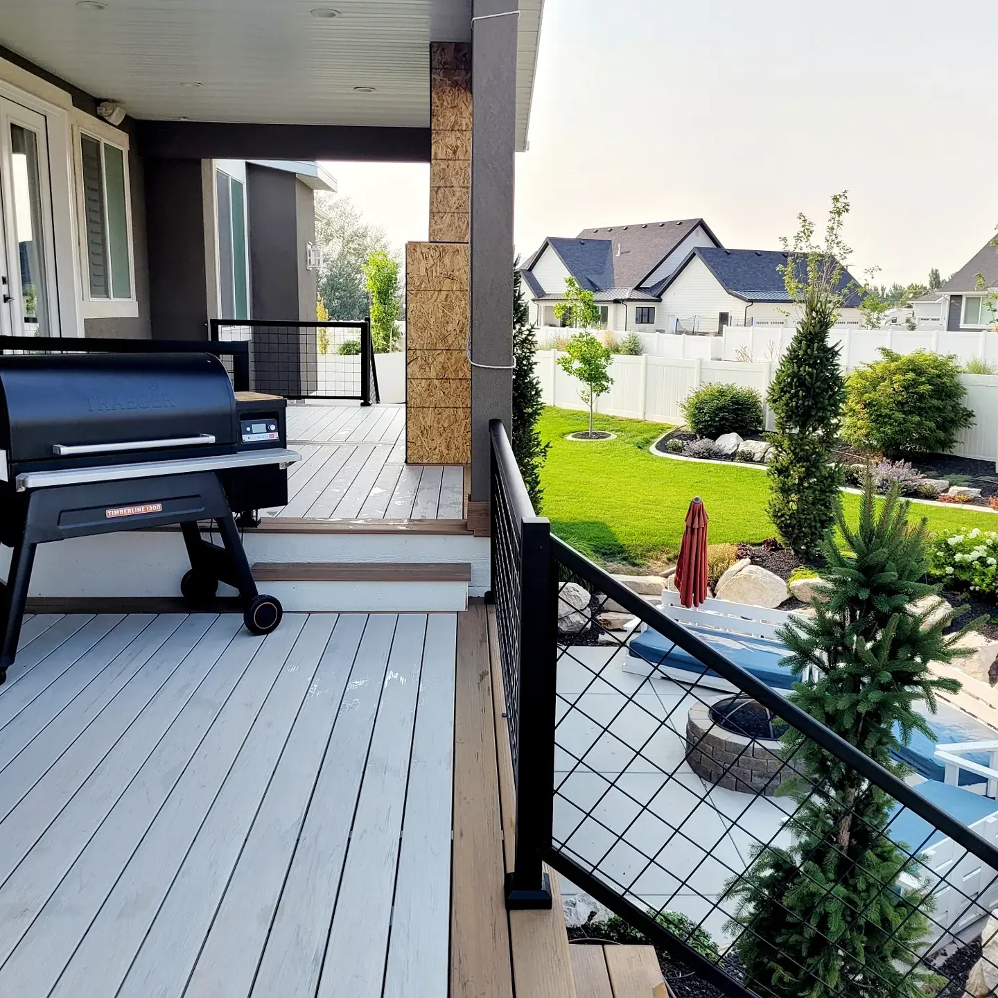 Black cable railing on a light gray composite deck