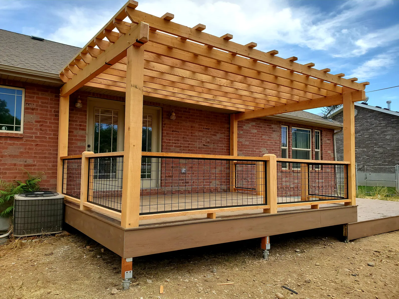 Wood pergola deck with mesh railing panels