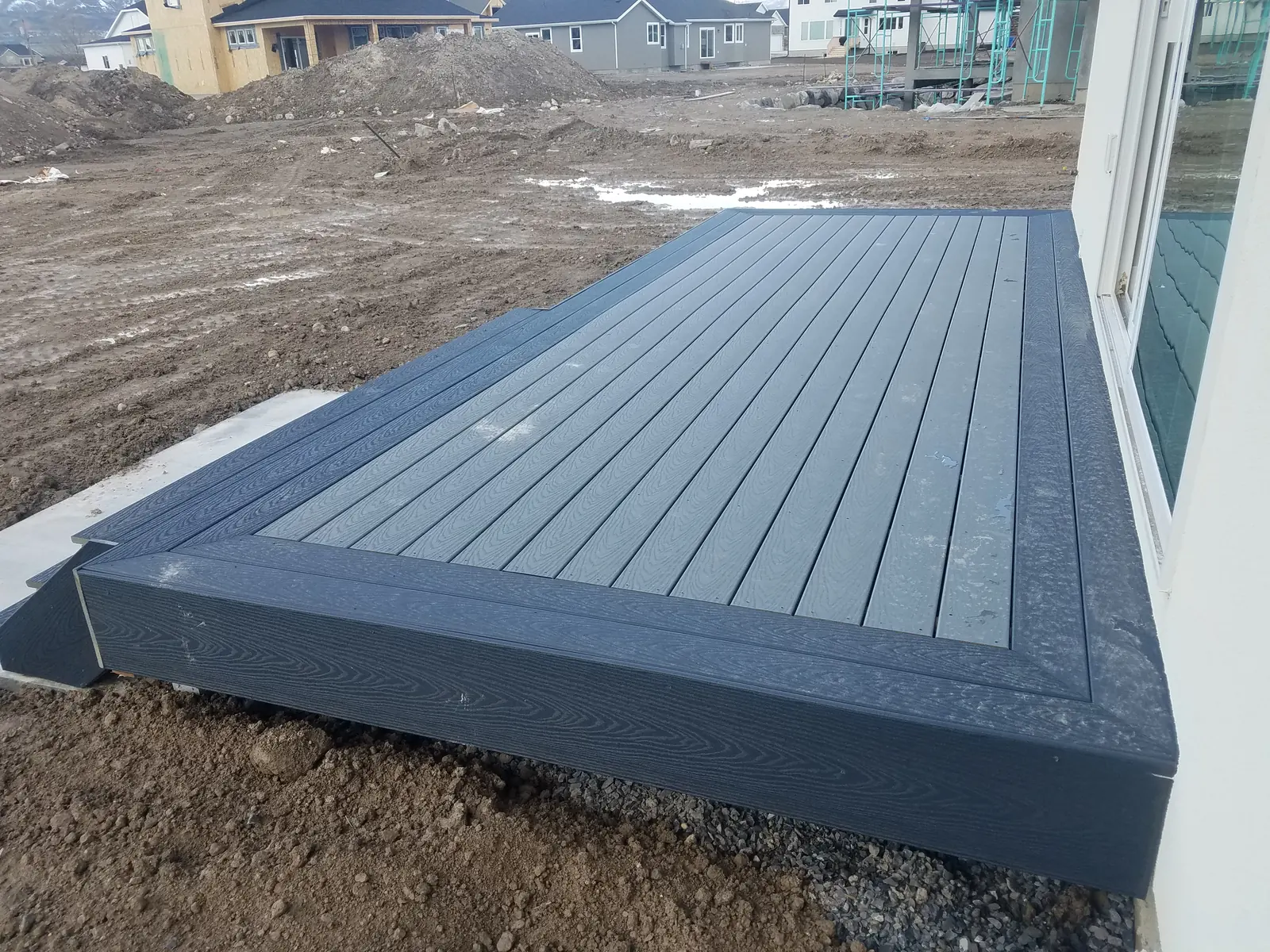 Ground-level composite deck with a dark picture-frame border