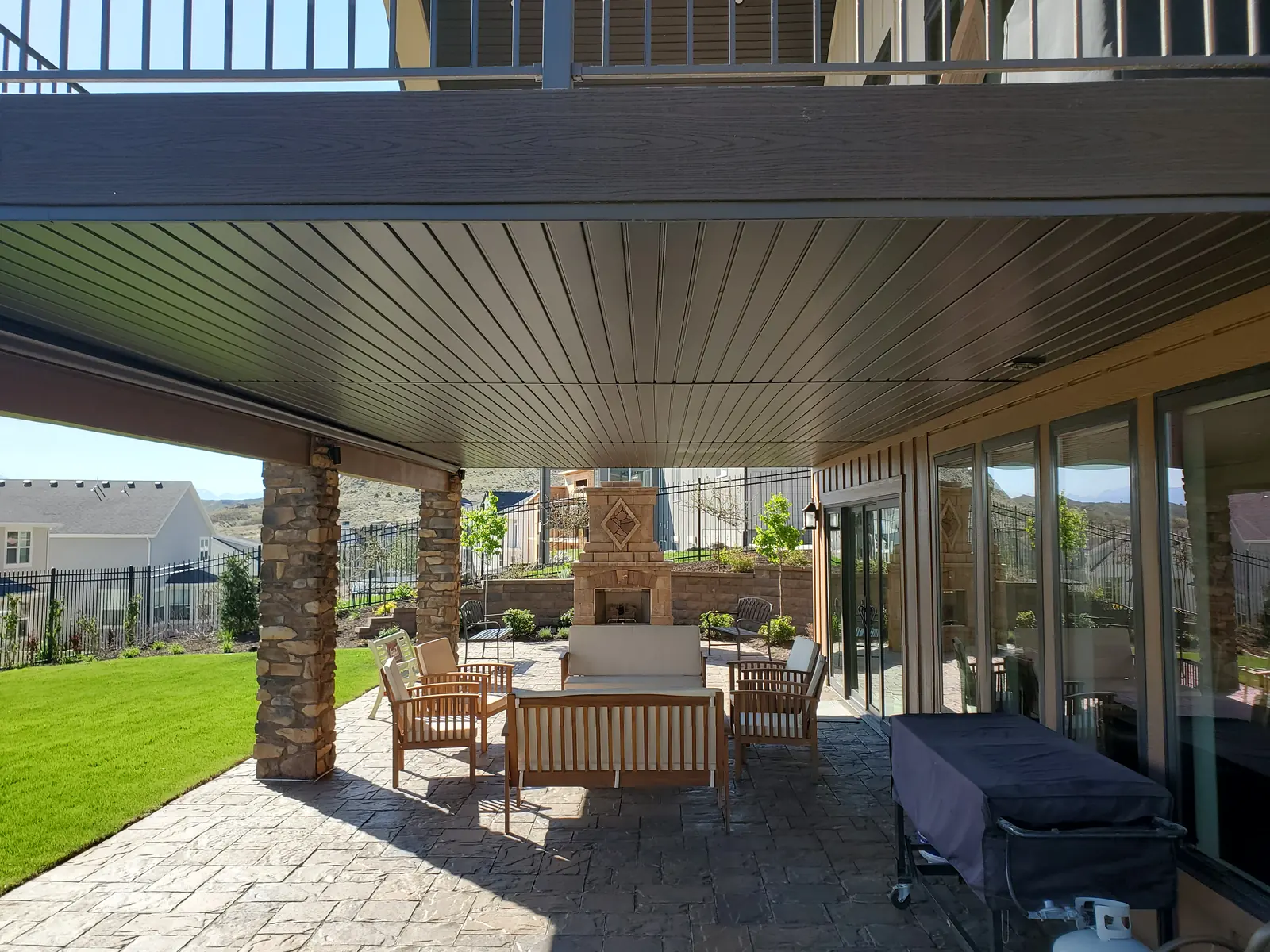 Dry patio under a deck with an under-deck drainage ceiling