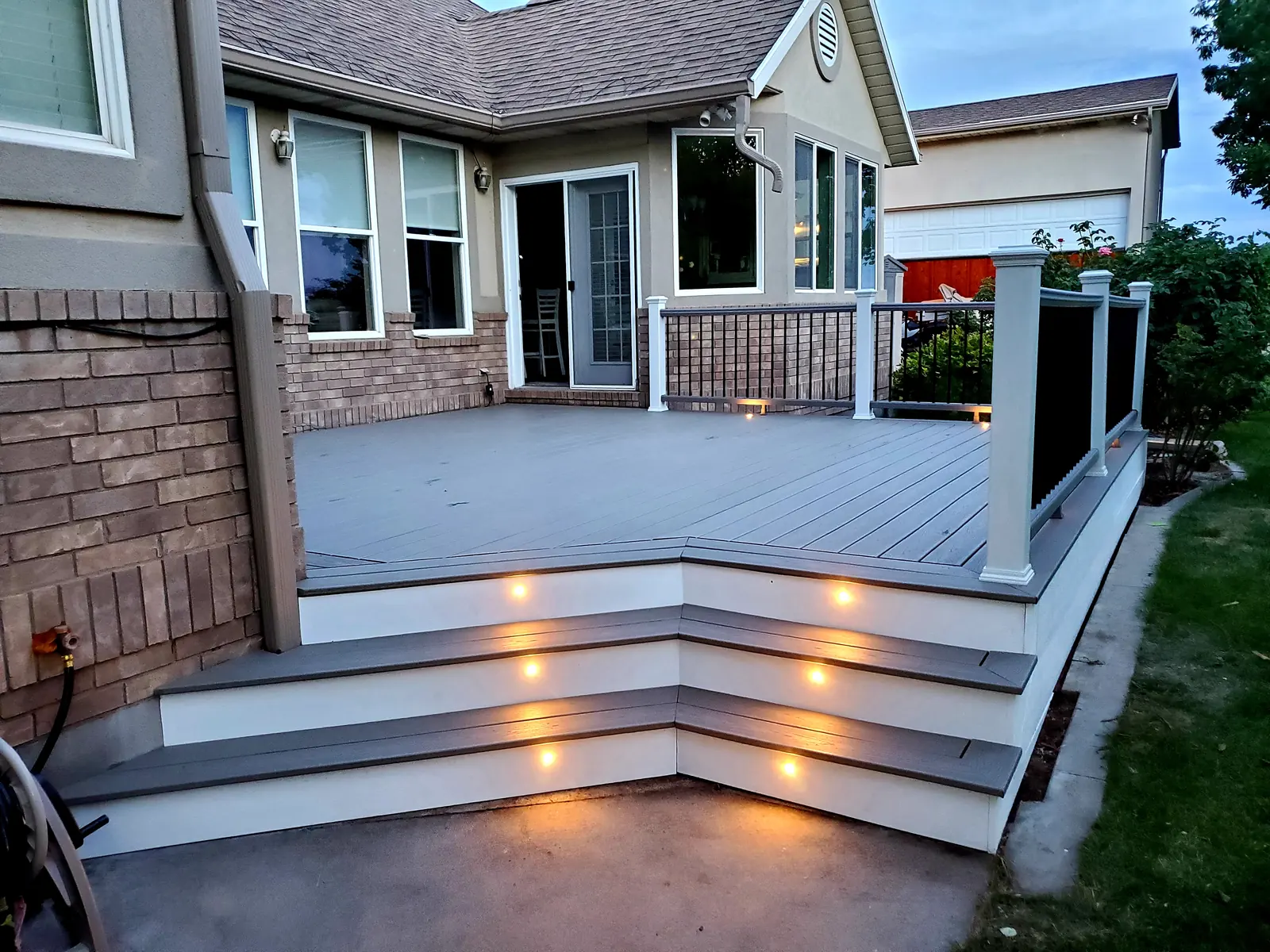 Wrap-around deck stairs with riser lights