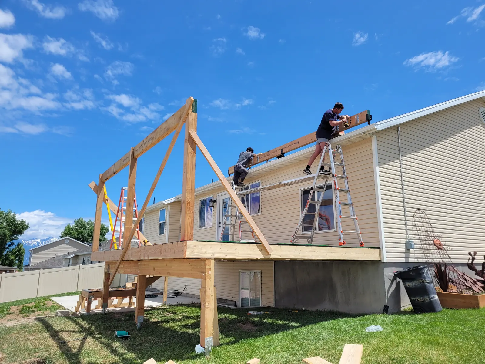 Side view of deck roof rafters and support beams during framing