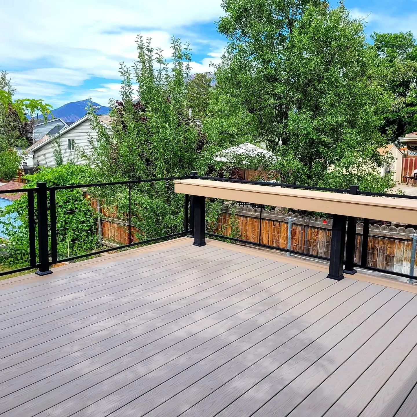 Two-tone TimberTech deck with a built-in bench built by TC Decks in Draper
