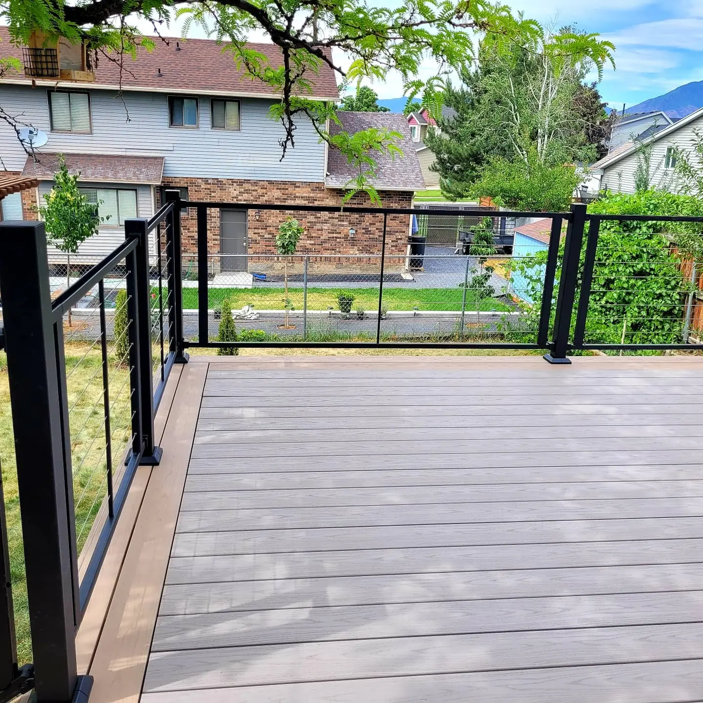 Slate Gray deck boards with a Brownstone picture frame and black cable railing