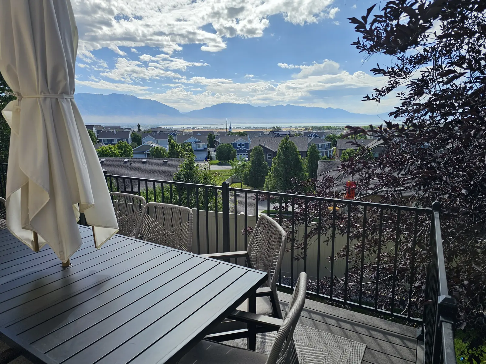 Black aluminum deck railing overlooking the valley