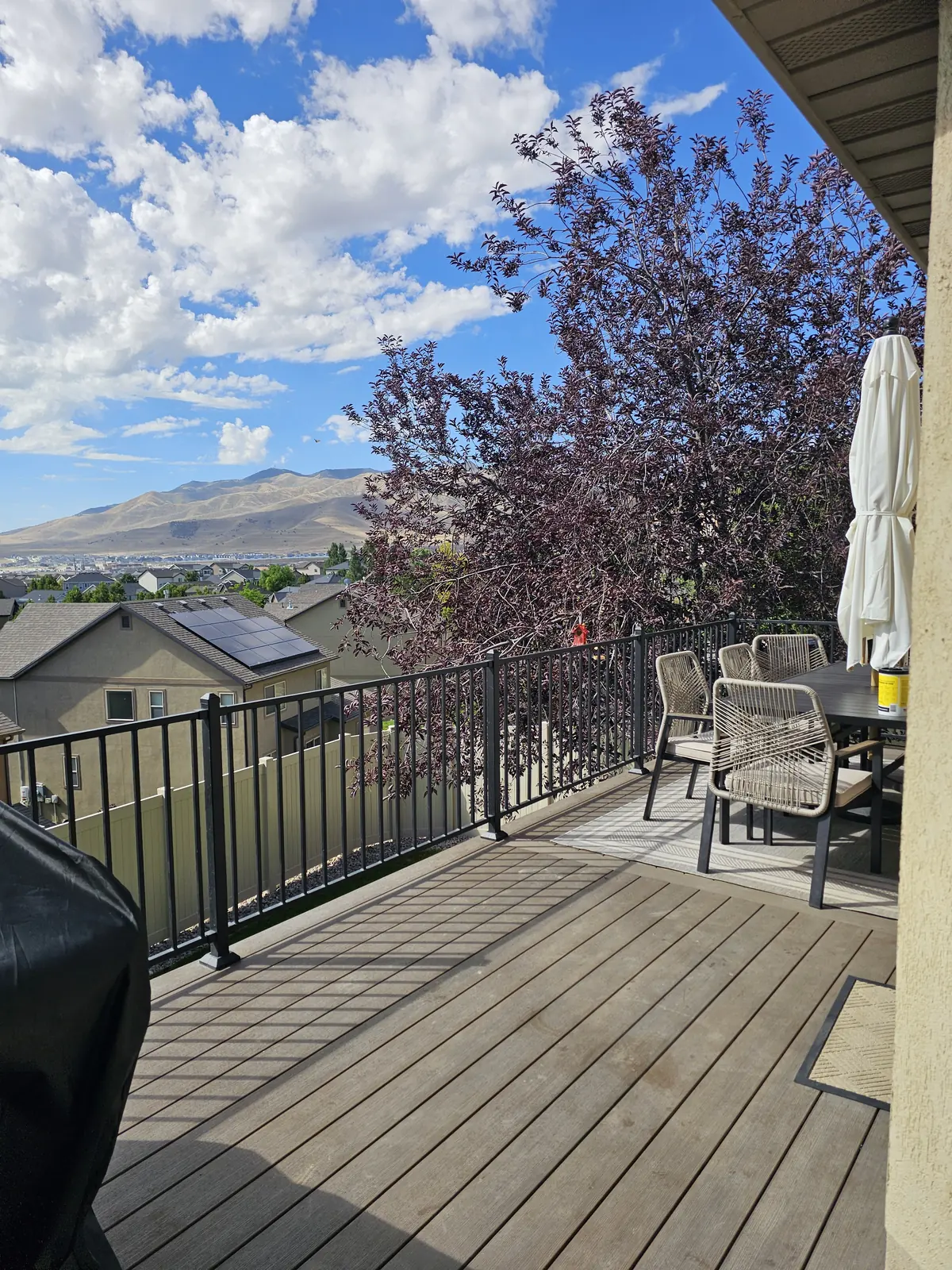 Dining set on a composite deck with a mountain view in Eagle Mountain