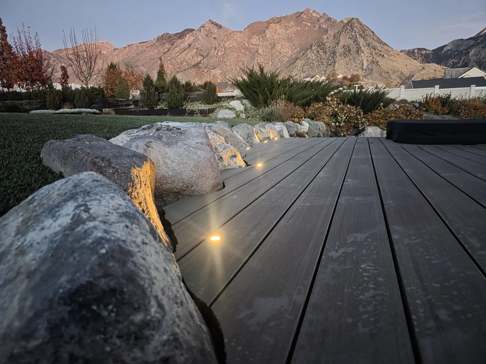 English Walnut deck scribed around boulders with a mountain view