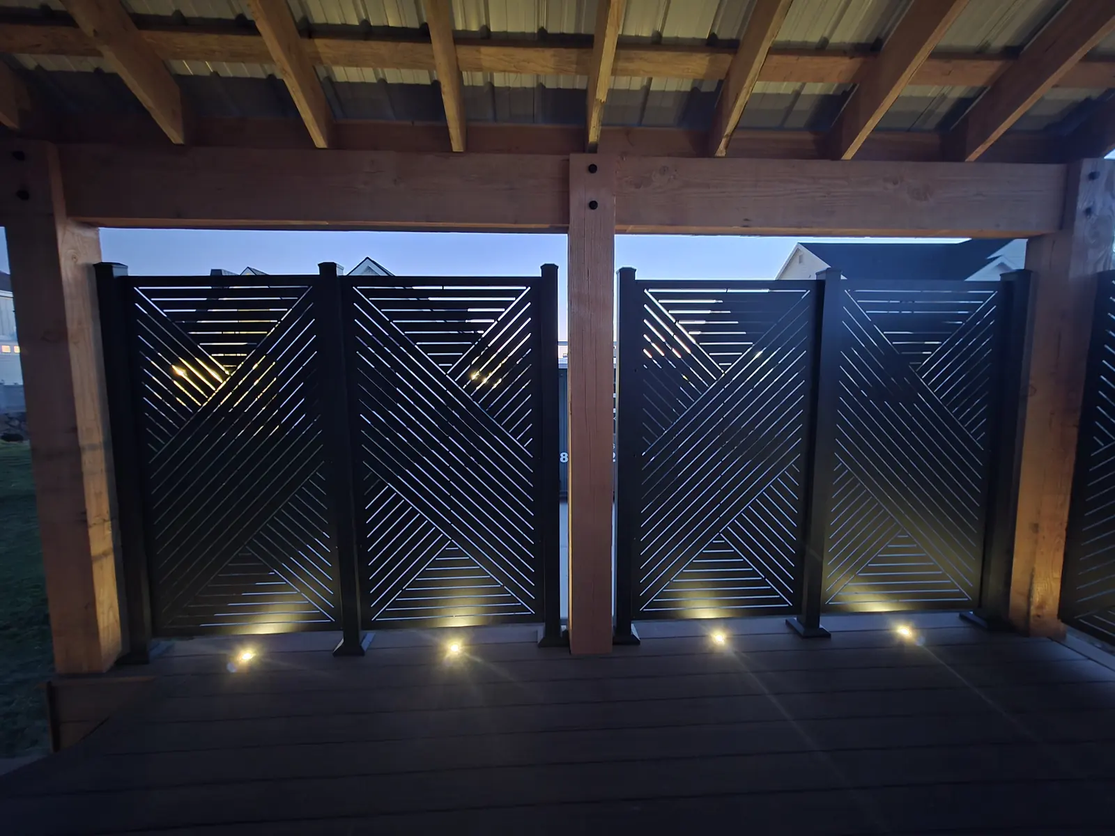 Wall of HideAway privacy screens lit by recessed deck lights