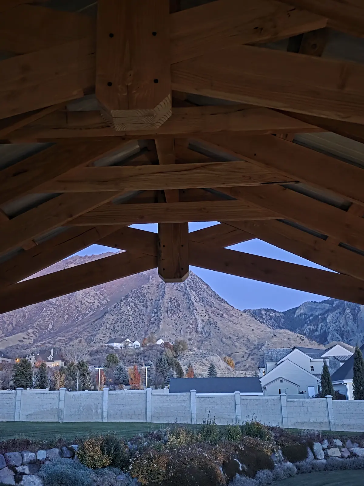 Timber truss pavilion framing a view of the mountains