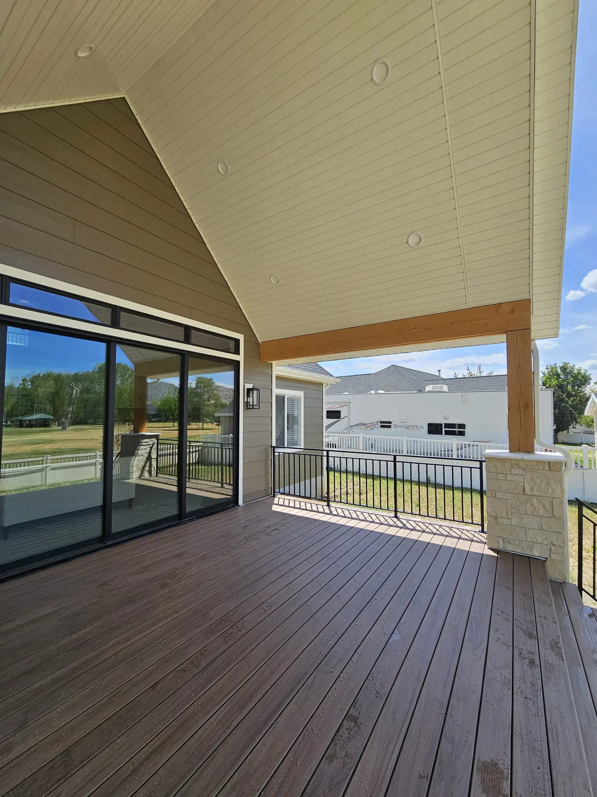 Vaulted ceiling with recessed lights over a TimberTech Legacy Pecan deck