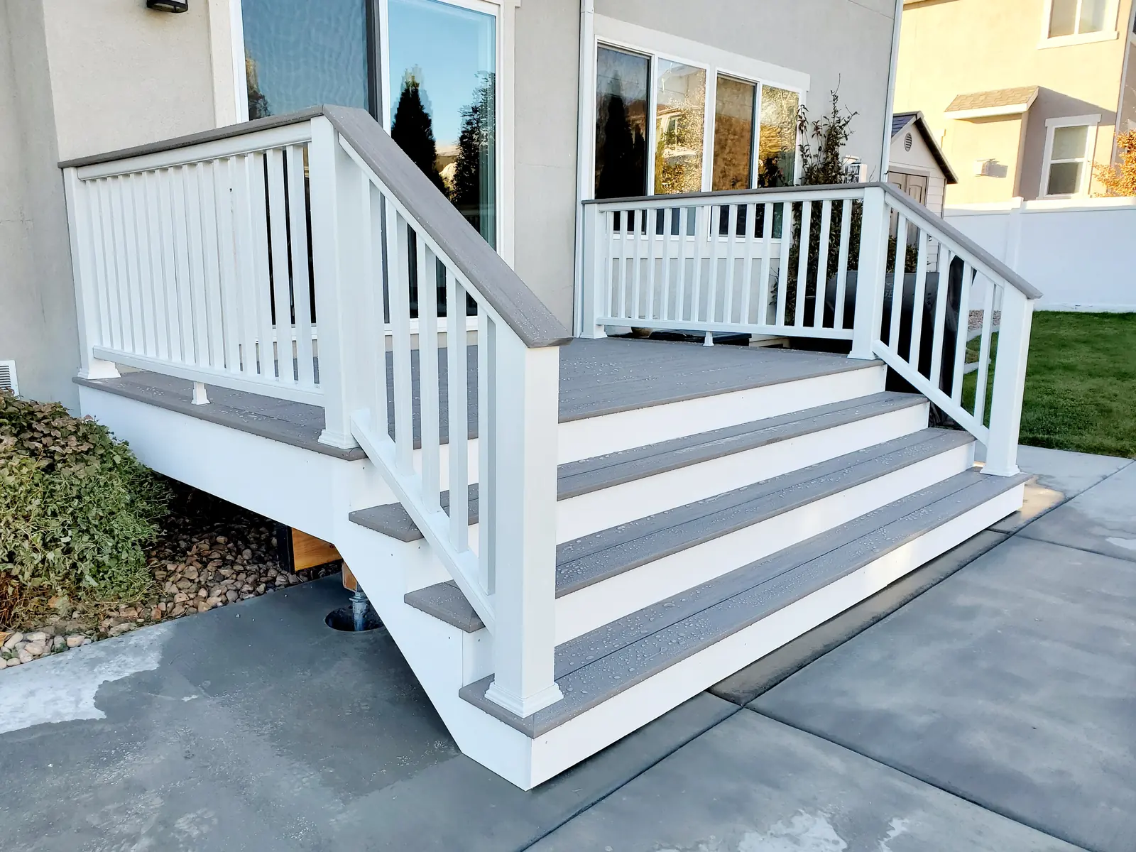 Gray composite entry stairs with white railing