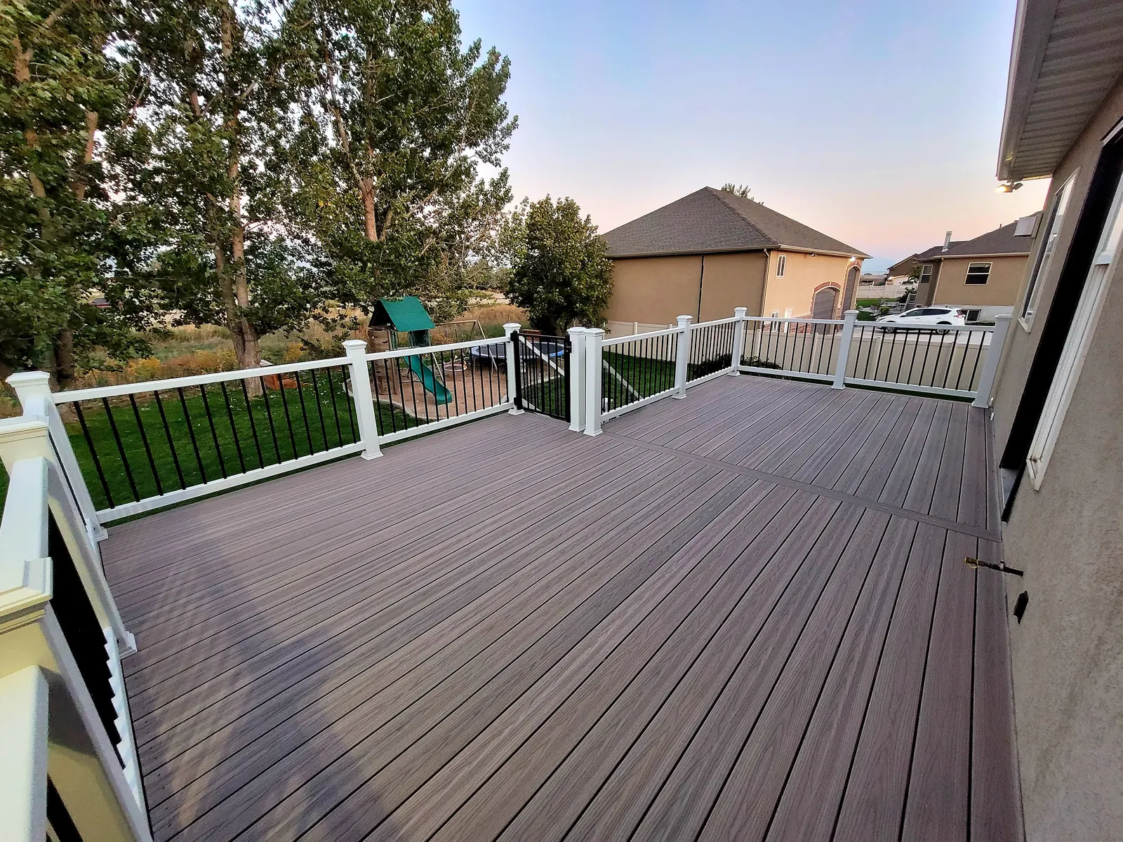 Large composite deck with white posts and black balusters
