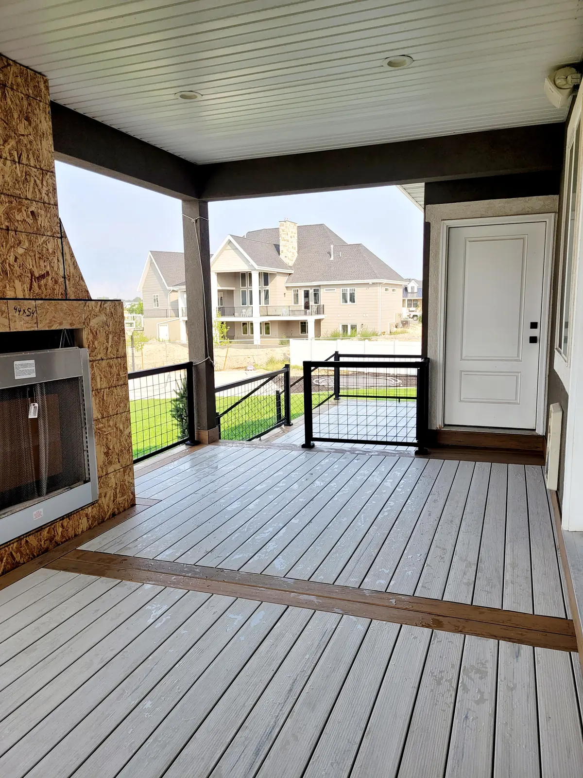 Light gray composite deck boards under a covered roof