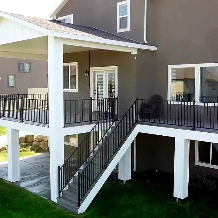 Covered second-story deck with white columns and black railing