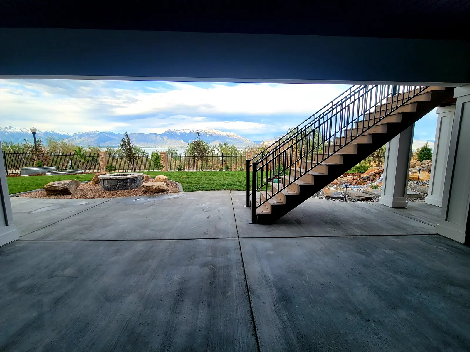 Covered patio under a second-story deck with stairs to the yard