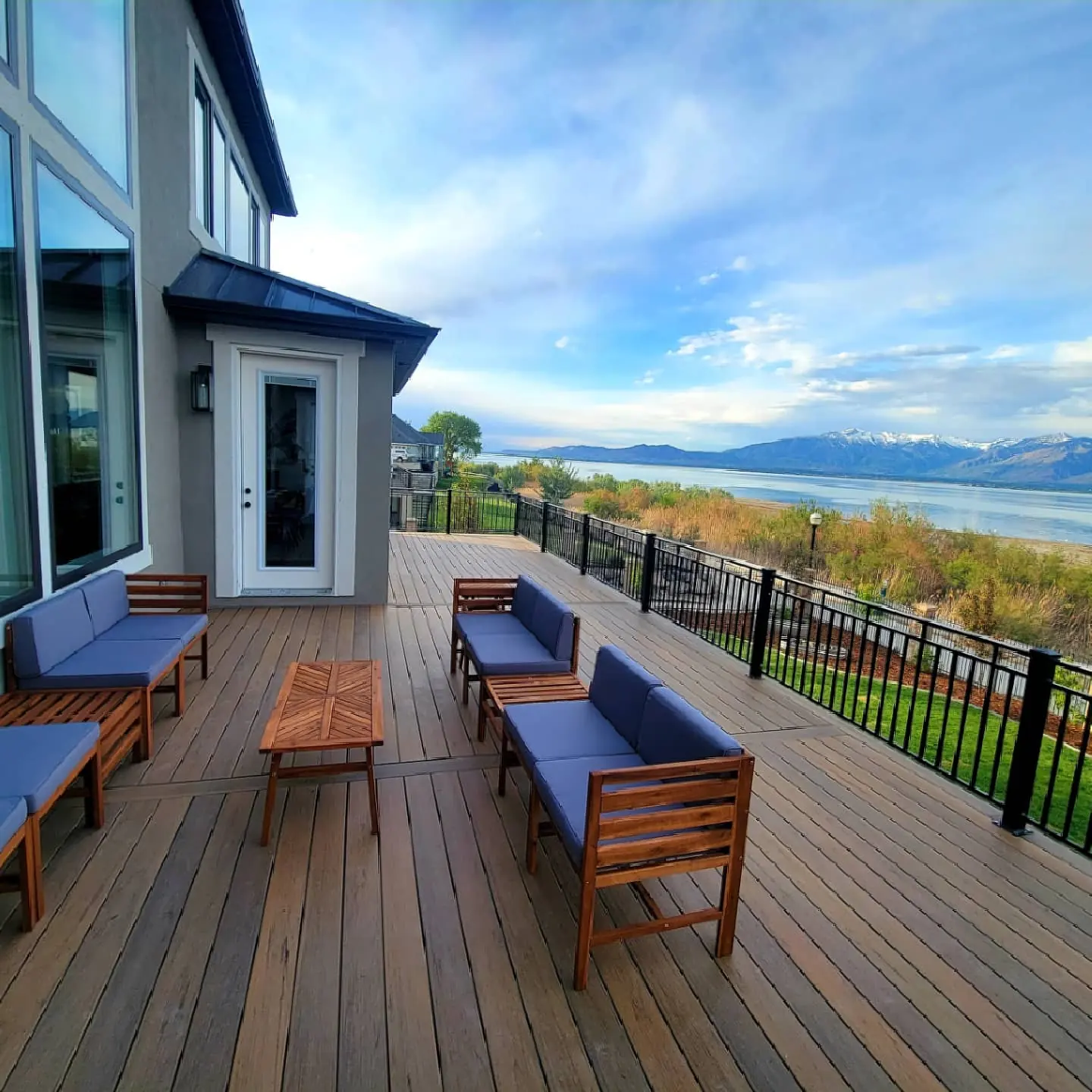 Lounge seating on a TimberTech Tiger Wood deck with Utah Lake and snowcapped mountains beyond