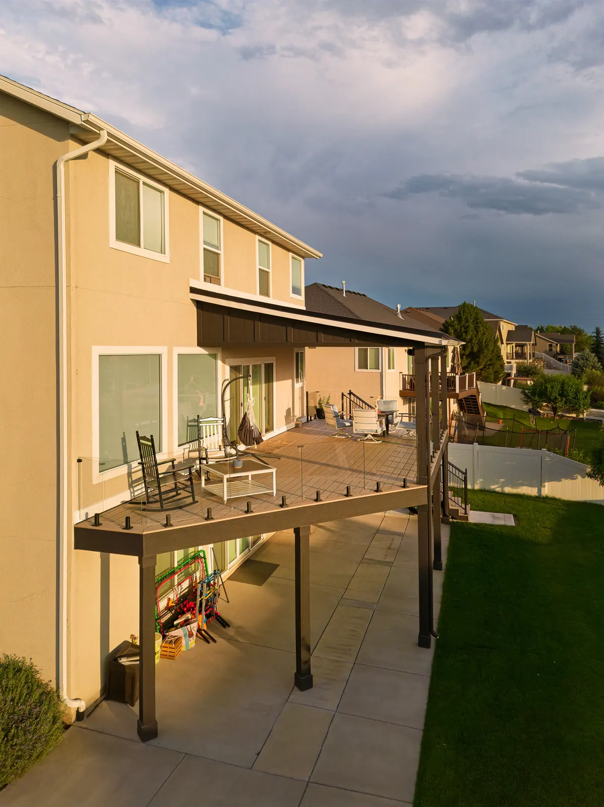 High-angle view of a covered deck with frameless glass railing