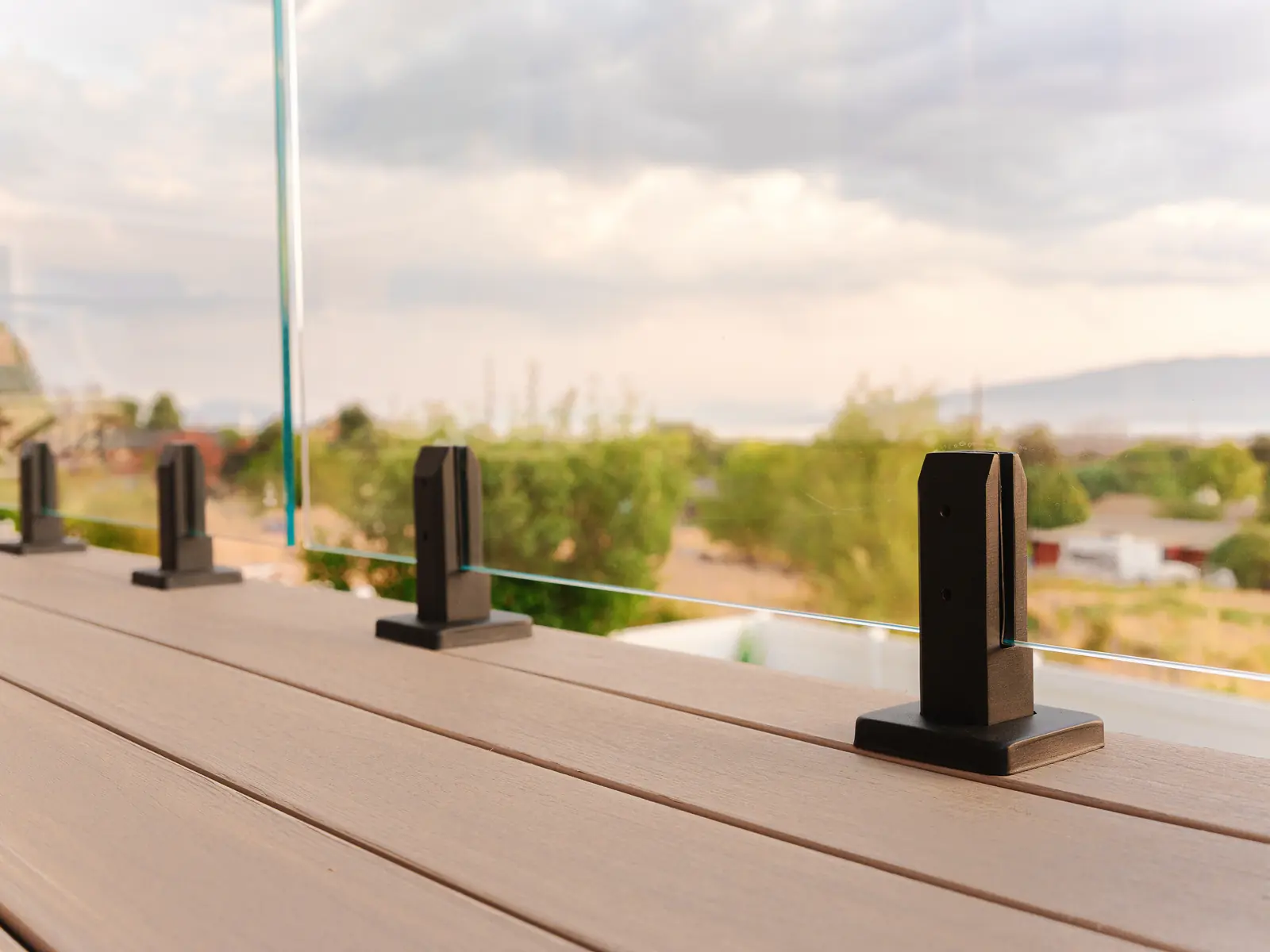 IG glass railing spigots on TimberTech French White Oak decking