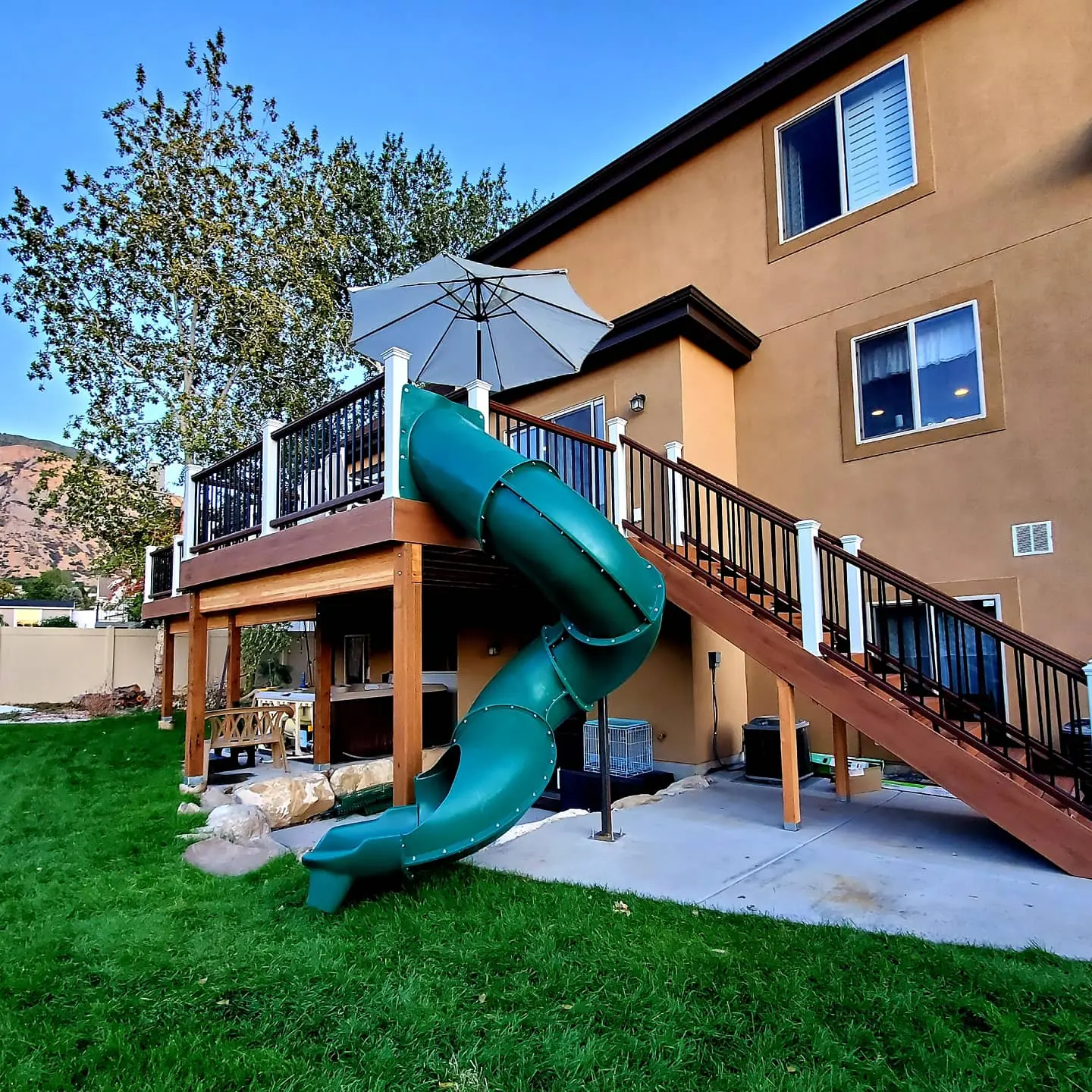 Trex deck with a twisty slide built by TC Decks in Pleasant Grove