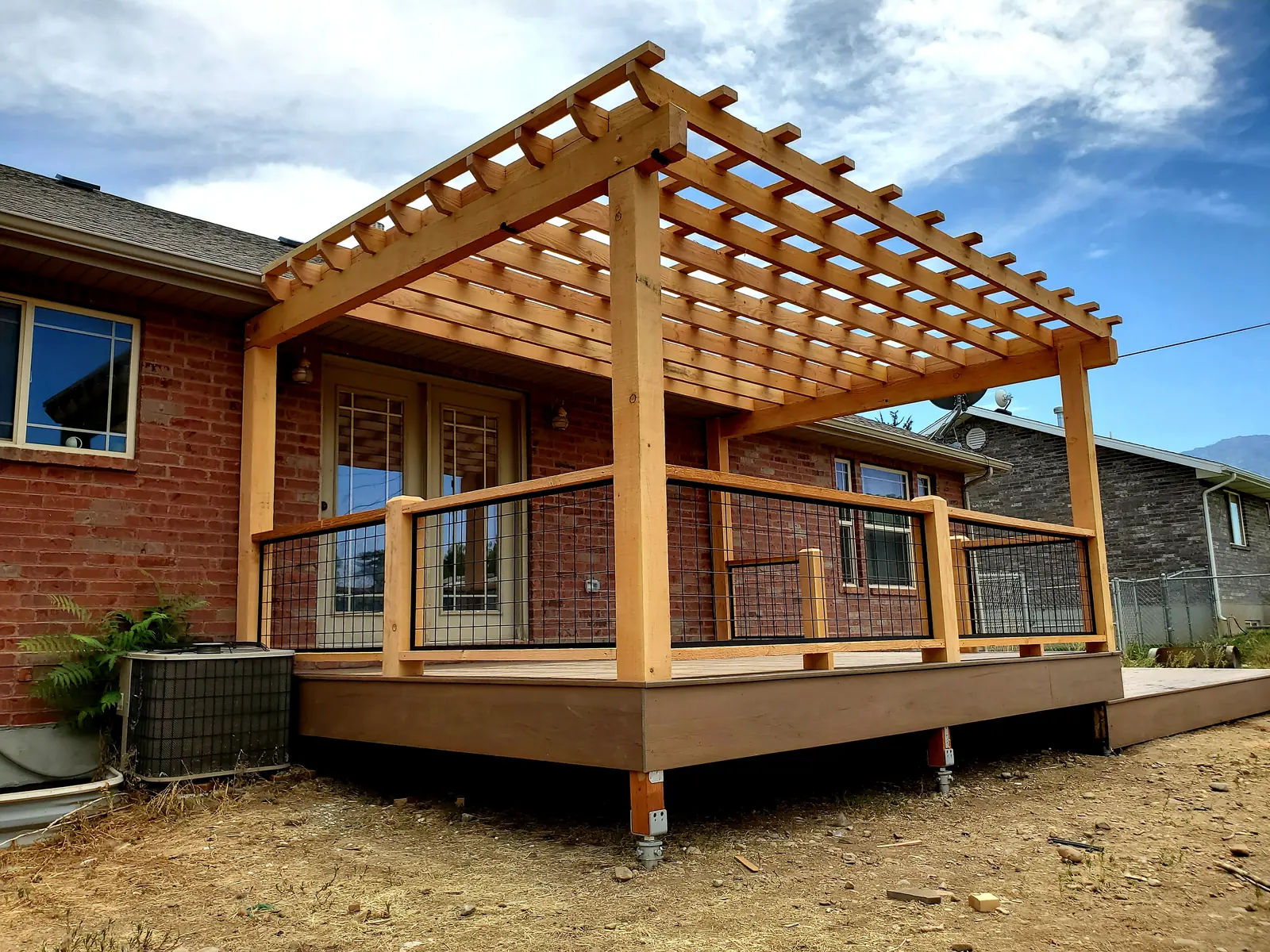 TimberTech Pecan deck with a natural wood pergola built by TC Decks in Santaquin