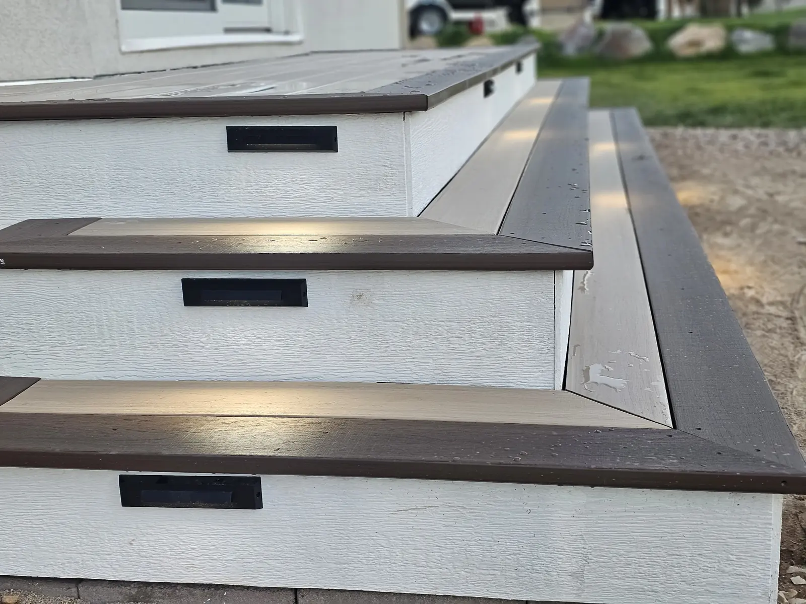 Close-up of mitered American Walnut stair nosing with recessed riser lights
