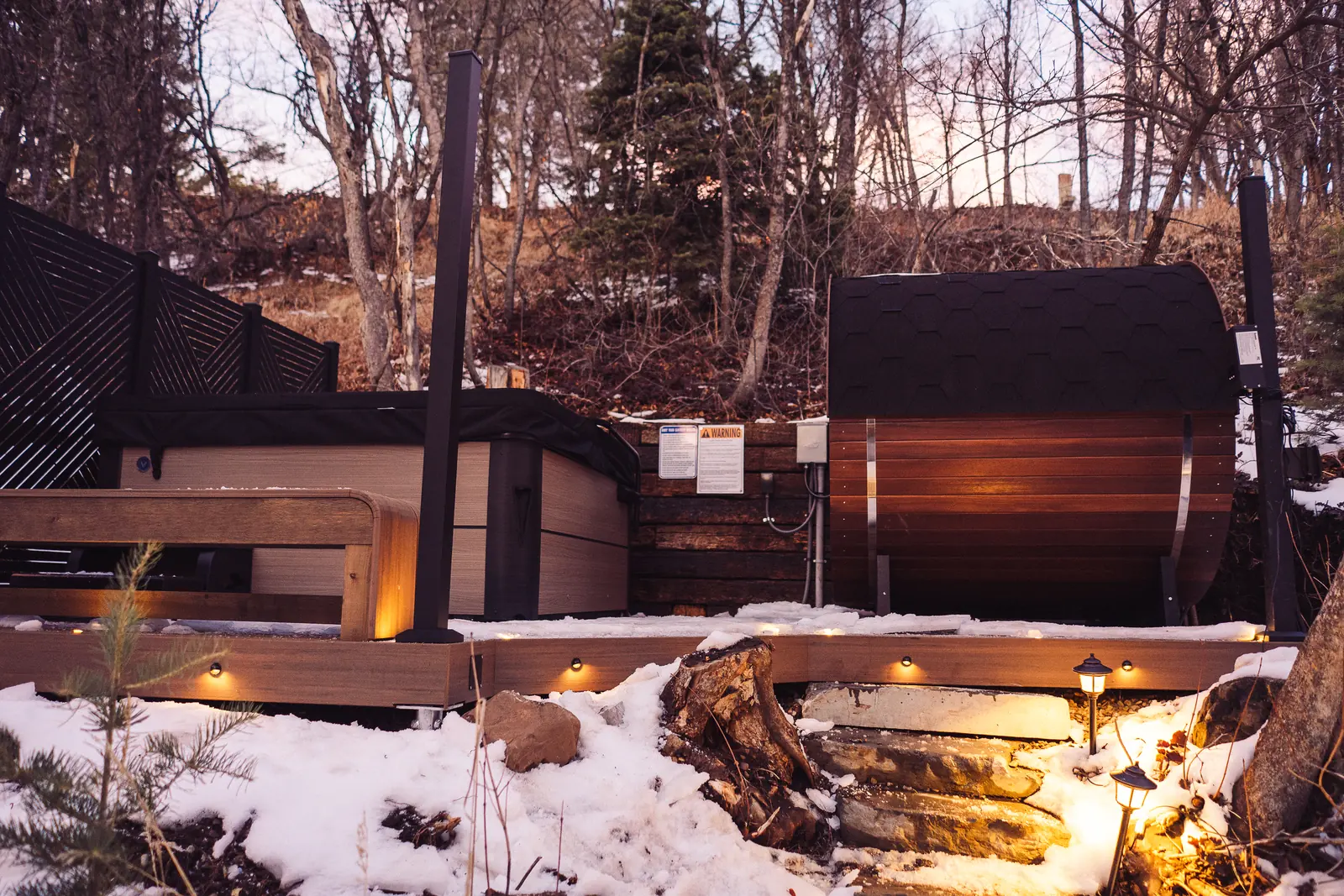 Hillside sauna and hot tub deck above lit stone steps