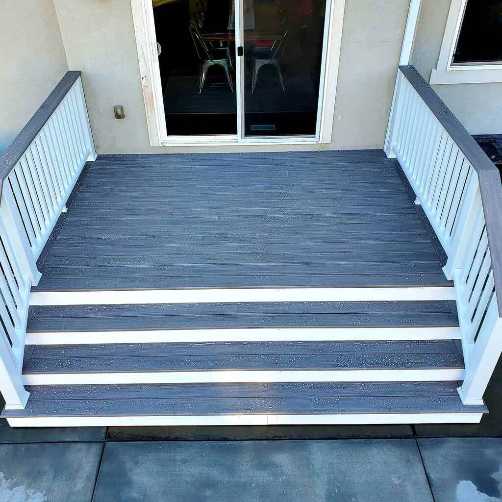 A white bench by TC Decks adorns a wooden walkway.