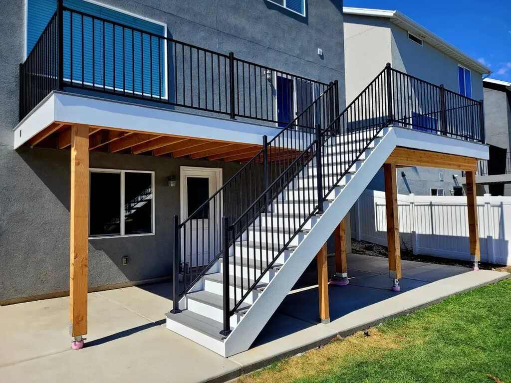 White staircases by TC Decks lead to beautifully arranged patio areas.