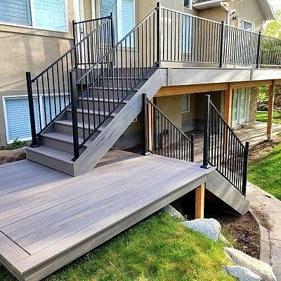 Luxury meets style on large wooden decks by TC Decks, featuring elegant staircases.