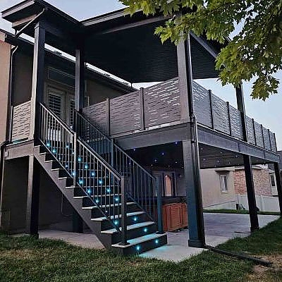 Stairways to large buildings by TC Decks feature elegant blue railings.