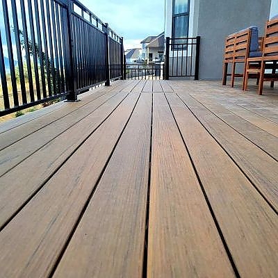 Masterful deck design by TC Decks includes benches and detailed wooden floors.