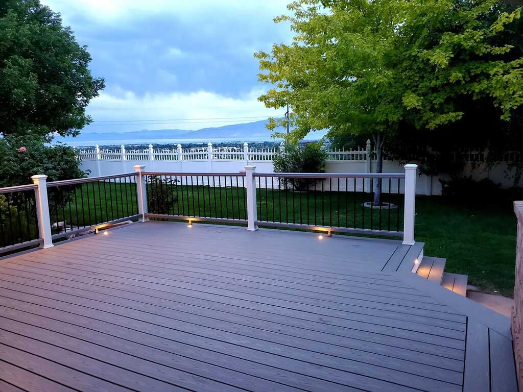 A fence and patio combination by TC Decks offers privacy and style.