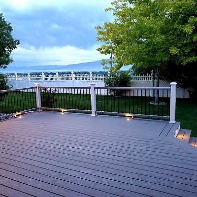 A fence and patio combination by TC Decks offers privacy and style.